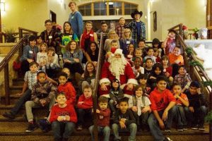 A group photo with Santa Claus by the Stairs