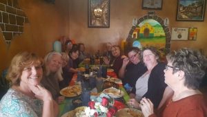 A gathering of adults on a dining table